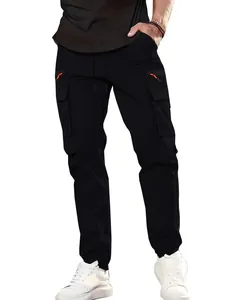 Front view detail of black cargo pants with multiple pockets and orange zippers