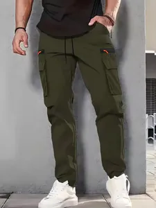 Close-up of men's olive green cargo pants featuring multi-pockets and vibrant orange accents