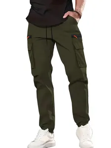 Detail view of men's olive green cargo pants with multi-pockets and orange zippers.