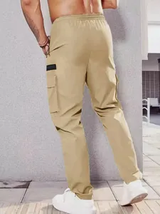 Back view showing the fit and multi-pocket design of khaki cargo pants in urban setting