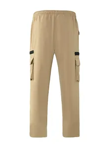 Detail view of khaki cargo pants featuring large side pockets and elastic waistband