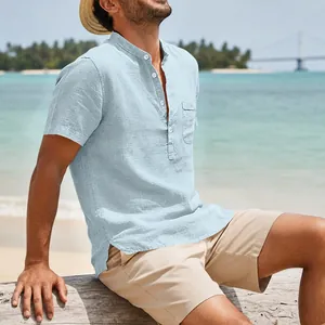 Detail of light blue men's linen beach shirt with Henley collar and chest pocket