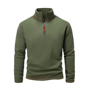 Close-up detail of men's olive green tactical fleece pullover with red accent stitching