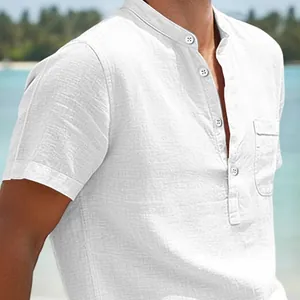 Close-up of a white linen beach shirt featuring a mandarin collar and chest pocket.
