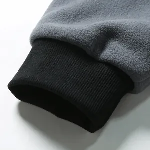 Detailed close-up showing the black ribbed elastic cuff on a gray fleece sweatshirt
