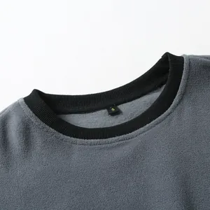 Close-up of grey fleece sweatshirt neckline with black ribbed trim and size S label.