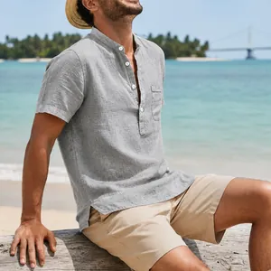 Side view of man wearing grey linen henley shirt on beach setting