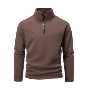 Detailed view of men's brown quarter-zip tactical fleece with red contrast stitching