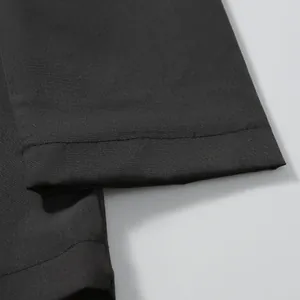 Close-up detail of a black windproof men's jacket showing clean stitching and fabric texture