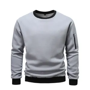 Close-up of men's grey fleece sweatshirt with black trim and sleeve zipper detail
