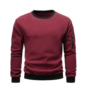 Detailed view of maroon men's fleece crewneck sweatshirt with black ribbed trim.