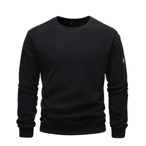 Close-up of a black crew neck sweatshirt featuring a utility zipper pocket on the sleeve