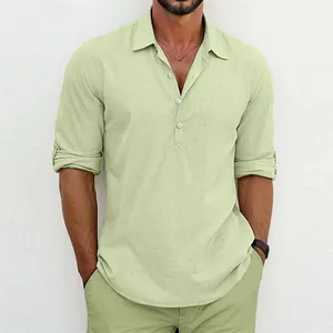Close-up of men's linen henley shirt in pale green showing fabric texture