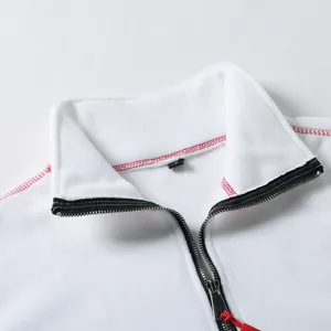 Close-up detail of white tactical fleece jacket with stand collar and red stitching