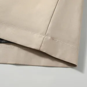 Close-up detail of khaki windproof jacket showing fine stitching and durable fabric texture