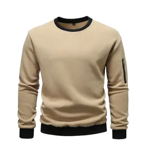 Detailed view of khaki fleece crewneck sweatshirt with black ribbed trim and sleeve zip