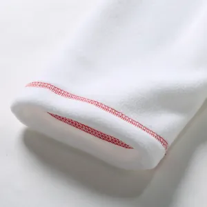 Detailed macro shot of white polar fleece garment cuff with red contrast stitching accents