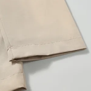 Close-up of windproof jacket hem with durable double-stitched craftsmanship details.