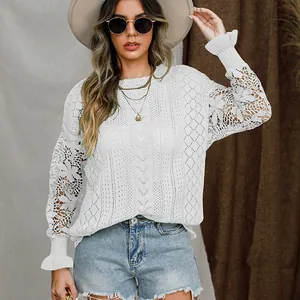 Elegant white knit sweater featuring floral lace sleeves and flared ruffled cuffs