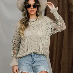 Detail view of beige knit sweater with floral lace sleeves and flared cuffs.