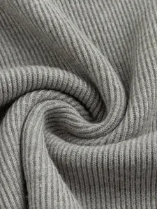 Close-up view of grey ribbed knit fabric texture showing soft and breathable material
