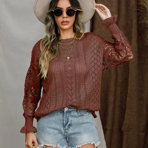 Close-up of a women's terracotta lace knit sweater with floral hollow patterns.