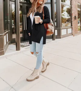 Stylish woman wearing a black long-sleeve knit cardigan with side slits and pockets