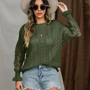 Close-up of green long sleeve knit sweater featuring intricate lace floral patterns.