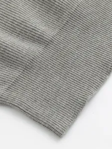 Close-up view of grey ribbed knit texture on a men's business casual sweater cuff.