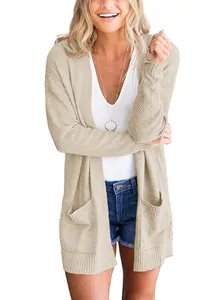 Detail view of a women's beige knit cardigan with large front pockets and ribbed cuffs.