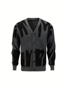 Macro detail of grey V-neck cardigan with bold abstract black pattern and buttons.