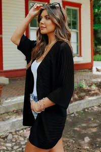 Close-up of black thin rib-knit cardigan with 3/4 sleeves for casual spring wear