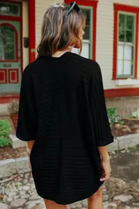 Detailed rear view of a women's black ribbed knit cardigan with loose half sleeves