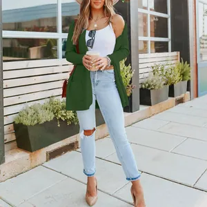 Stylish dark green loose knit cardigan sweater for women in outdoor urban street setting
