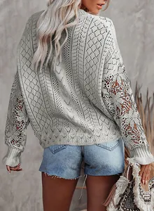 Back view of a grey pointelle knit sweater with intricate lace hollow-out sleeves