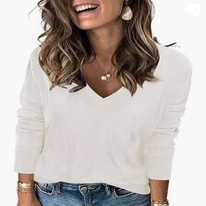Close-up of white V-neck knit sweater with vertical ribbed texture and long sleeves