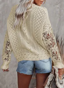 Detailed view of cream hollow-out knit sweater featuring intricate lace patterns.