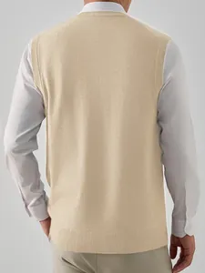Detailed back view of a men's beige V-neck knit sweater vest over a white shirt