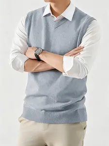 Detail shot of men's gray V-neck knit sweater vest layered over white shirt