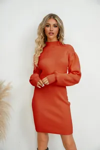Detail of a burnt orange ribbed knit mini dress with high neck and puffed sleeves