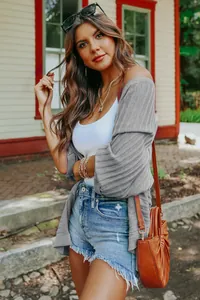 Detail view of a grey ribbed knit cardigan with loose 3/4 sleeves for casual wear.
