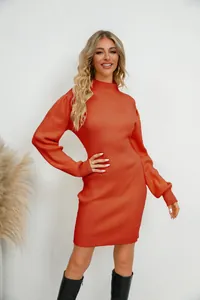Elegant orange ribbed knit dress featuring a mock neck, shown in a lifestyle studio setting