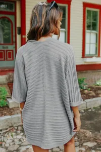 Back view of women's grey rib-knit cardigan showing v-shape texture and loose fit