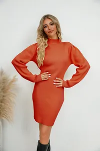 Elegant rust orange ribbed knit dress with puffed sleeves on a blonde model