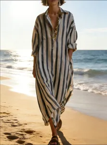 Elegant loose-fit striped V-neck dress with nine-quarter sleeves and pockets at sunset beach