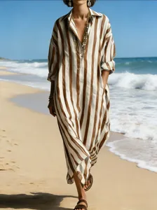 Full length view of a casual V-neck loose striped maxi dress with pockets on beach