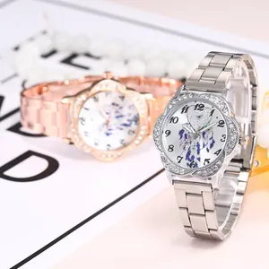 Close-up of women's quartz watch with rhinestoned flower bezel and dreamcatcher dial
