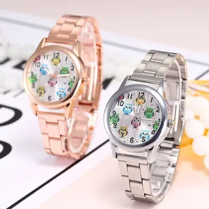 Close-up of trendy women's quartz watches with colorful owl pattern on white dials