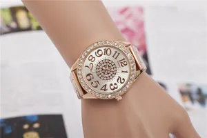 Detailed view of women's rose gold watch with sparkling rhinestone bezel and dial