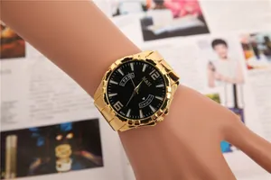 Close-up of an elegant gold ladies watch featuring a black dial and calendar display